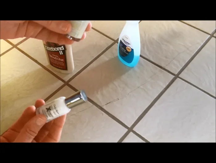 Apply the mixed nail polish over the dried wood glue, gently blending it into the surrounding tile. Work in small sections to ensure a natural blend.