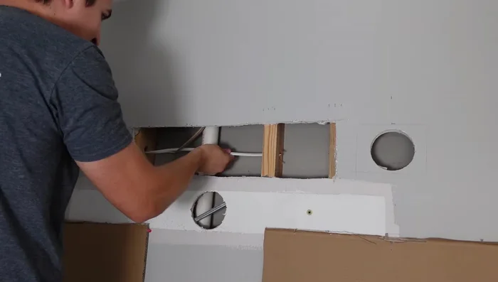 Run 14 gauge three-conductor wire from one light to the other, splicing and connecting with wire nuts.