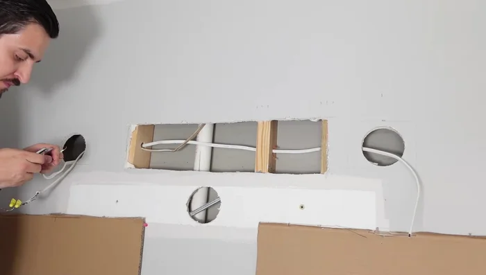 Run wires through clamps. Attach the junction box to the wooden piece and add the light fixture mounting plate.