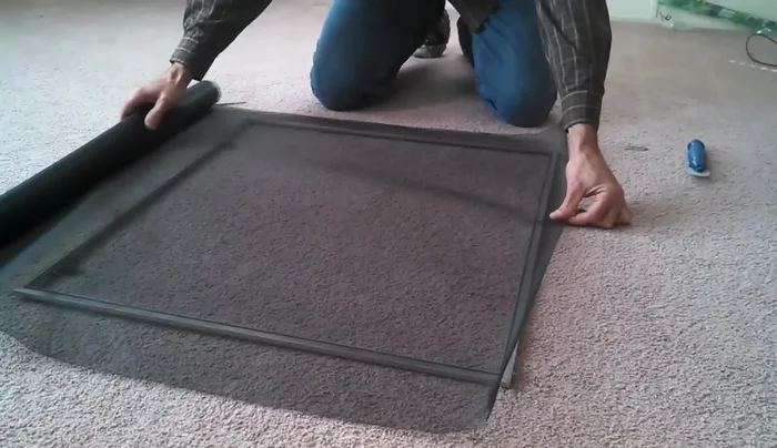 Insert the spline, starting at the edge with the ridge and working your way around the frame. Take extra care at the corners.