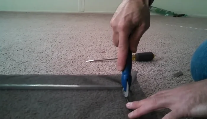 Insert the spline, starting at the edge with the ridge and working your way around the frame. Take extra care at the corners.