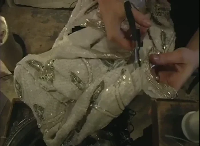 Use the salvaged embellishments and fabric pieces to decorate and enhance other clothes. Consider the size and shape when attaching them to new garments.