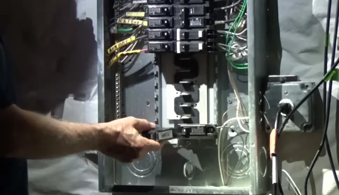 Add the new 20-amp breaker to the breaker bus bar.