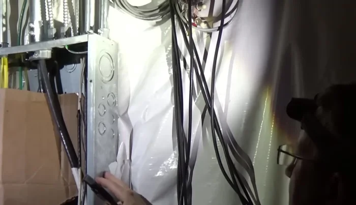 Slide the box spacers into the service panel and connect with nuts.