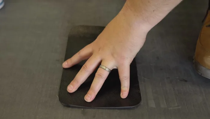 Position the patch over the damaged area and mark the perimeter.