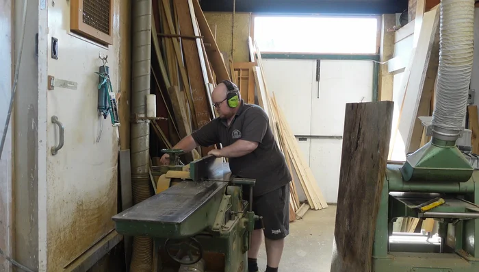 Rough cut the boards to manageable sizes for the panel saw. Use the saw's fence with a simple plywood backing piece and reference lines for accurate cuts.