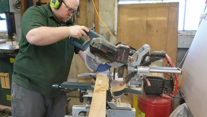 Rough cut the boards to manageable sizes for the panel saw. Use the saw's fence with a simple plywood backing piece and reference lines for accurate cuts.