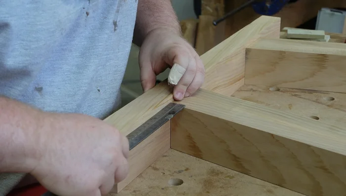Cut half-lap joints on the top stretcher using a simple jig. Plane off burn marks.