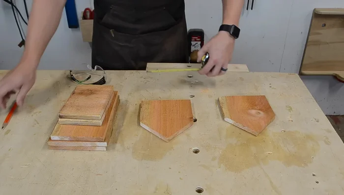 Drill a hole in the center of the front piece. Measure the center point (about 3 inches on a 6-inch wide piece) and use a Forstner bit (1 3/8 inches wide) or hole saw to drill the hole. Drill from the outside to get a clean circle.