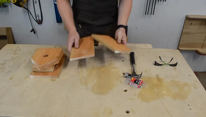 Assemble the roof by nailing the shorter piece to the longer piece.