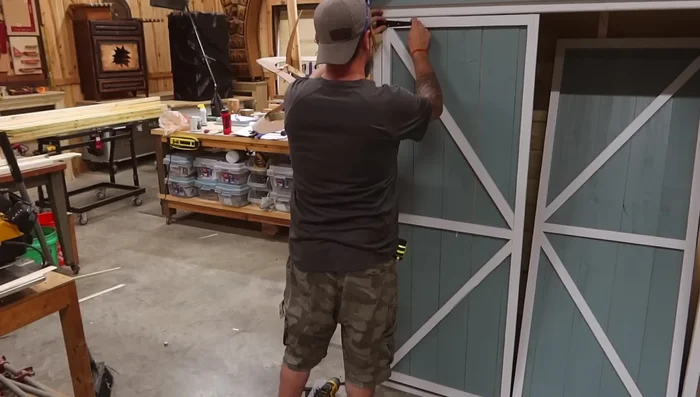 Install trim and fix gap between doors with an overlay board.
