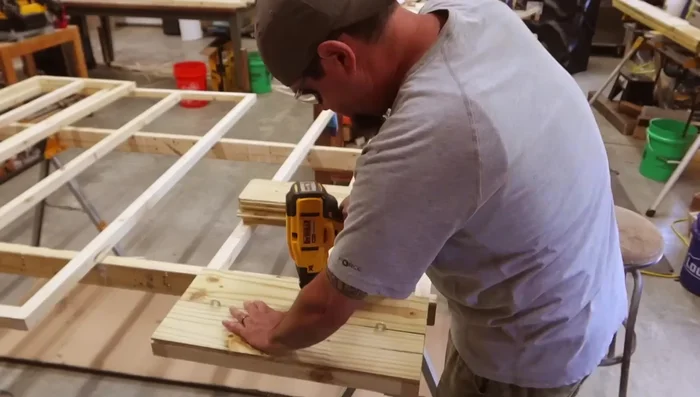 Install shiplap to trusses, leaving a vent on the front.