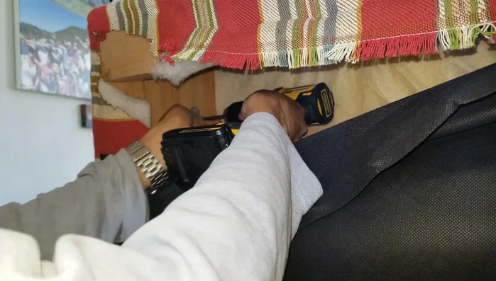 Drill screws to attach the L-brackets securely.