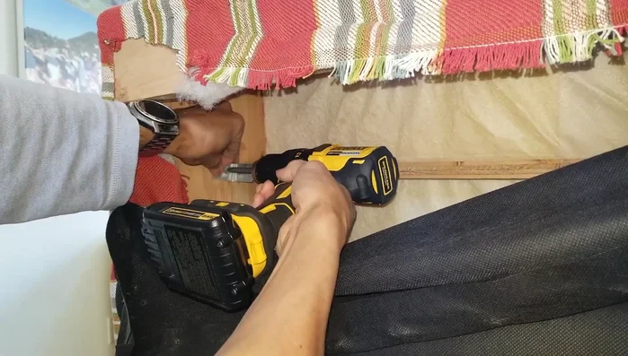 Drill screws to attach the L-brackets securely.