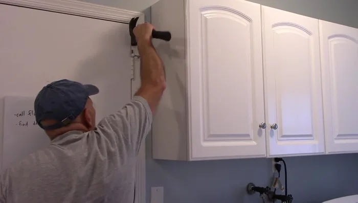 Use the hammer to tap the pin back down until secure.