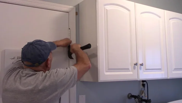 Once the pin is slightly loosened, use a screwdriver to push it up and remove it completely.