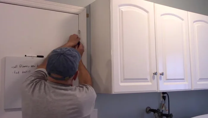 Once the pin is slightly loosened, use a screwdriver to push it up and remove it completely.