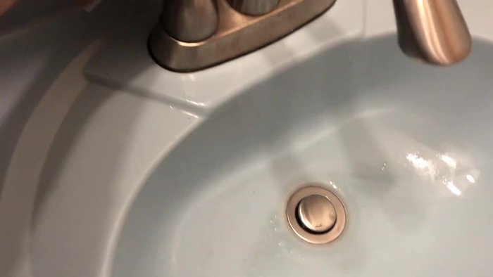 Remove the plastic cap securing the lever by turning it counterclockwise.