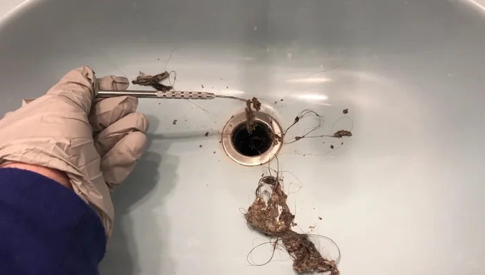 Clean the stopper and drain thoroughly using metal picks to remove debris.