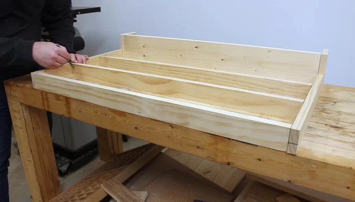 Attach the second side piece to complete the shelf units.