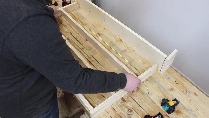 Attach the second side piece to complete the shelf units.