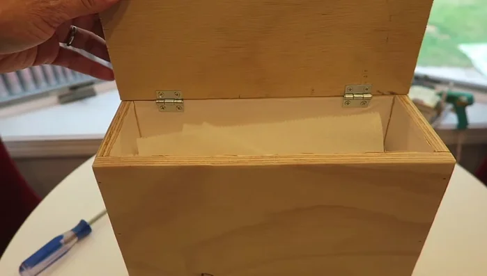 Attach hinges to the lid, ensuring it doesn't press against the wall when opened.
