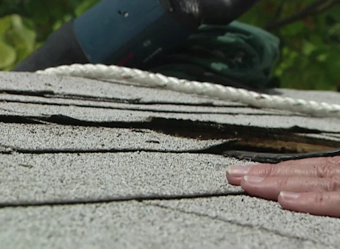 Pry up the shingles carefully using a pry bar to create space for the flashing.