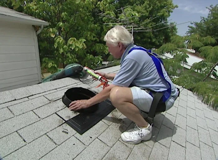 Apply silicone sealant around the flashing and under the shingles.