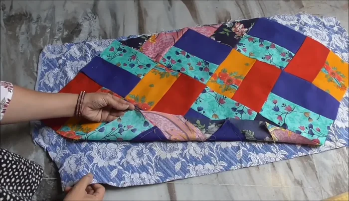 Stitch around the edges of the quilted block to attach it to the backing.