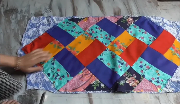 Stitch around the edges of the quilted block to attach it to the backing.