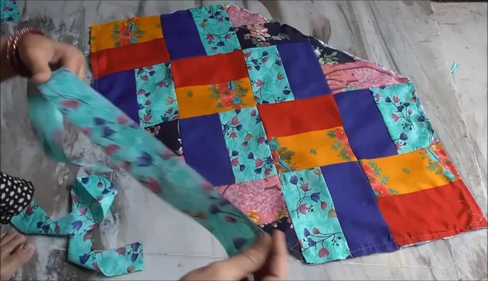 Finish the corners neatly by folding and stitching the fabric strip.