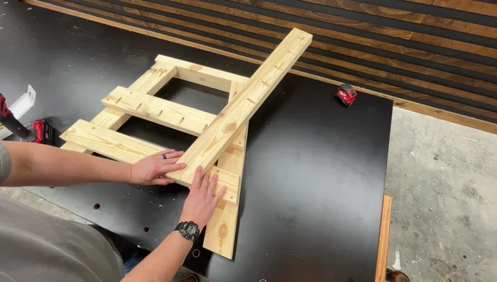 Attach the backrest support: Position the backrest support flush against the bottom support and top corner of the seat support, fasten with 2-inch wood screws.