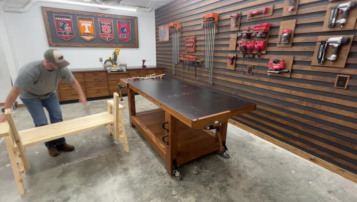 Attach the backrest boards: Space the first board from the seat using a 5/8-inch thick scrap wood. Fasten with pocket hole screws. Repeat for remaining boards, spacing with 2-inch screws. The top three boards overhang the armrests.