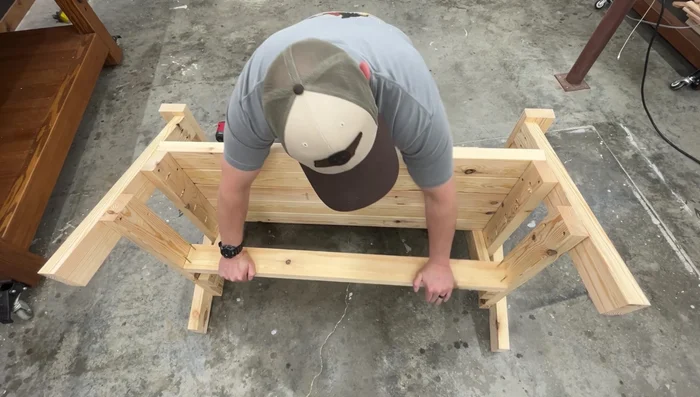 Attach a stretcher underneath the seat to add strength and prevent swaying. Fasten with 2-inch screws.