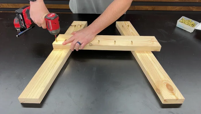 Attach the backrest support: Position the backrest support flush against the bottom support and top corner of the seat support, fasten with 2-inch wood screws.