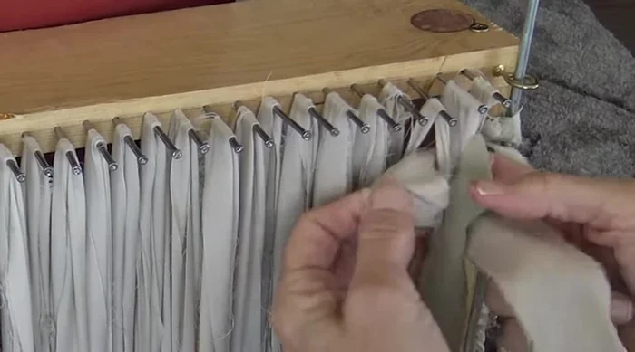 Continue weaving: Continue the under-two-over-two pattern across the loom. At the end of each row, wrap the weaving around the steel rods, switching the order of your colors.