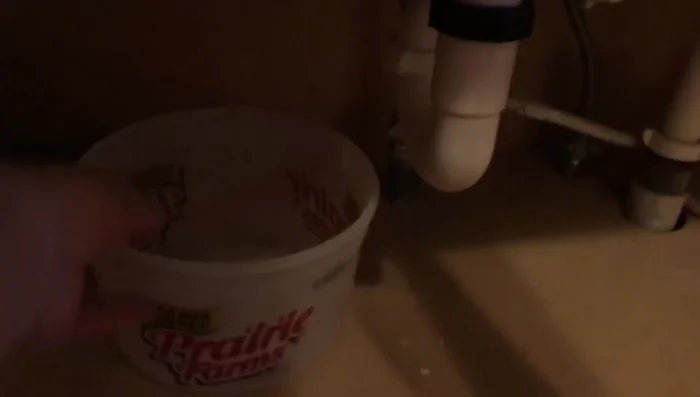 Place a bucket under the hose to catch water.