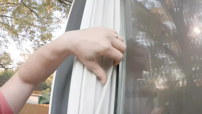 Remove vinyl strips from the window casing using a putty knife. Pry gently, working up and down to avoid breaking them. If a strip is stuck, use the putty knife to get it far back in the groove before pulling.