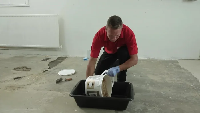 Mix the Concrex: Put the aggregate on the mixing tray, make a well, and add the hardener bottles. Mix thoroughly until smooth.