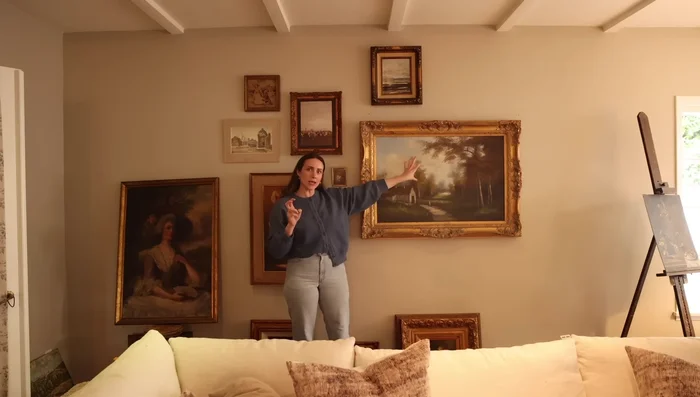 Refine the gallery wall arrangement. Adjust placement, considering balance and visual appeal.