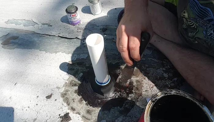 Feather out the tar to create a smooth, weatherproof seal.