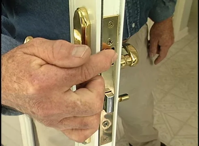 Position the strike plate using plumber's putty to create an impression for accurate placement. Then screw the strike plate in place.