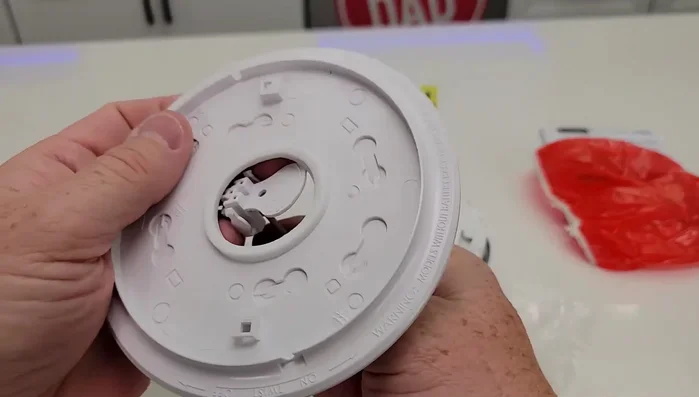 Install the new base, ensuring proper wire connection.