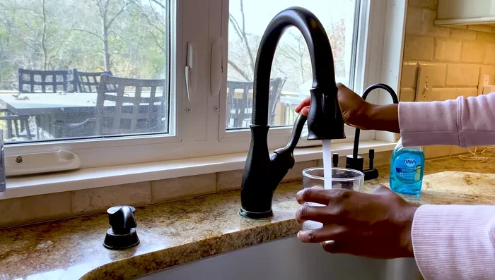 Let the vinegar sit for three hours to dissolve the hard water deposits.