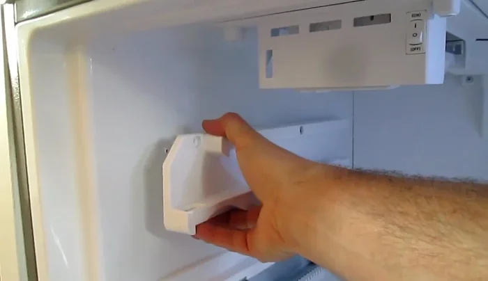 Remove ice maker and side rails to access the drain completely.