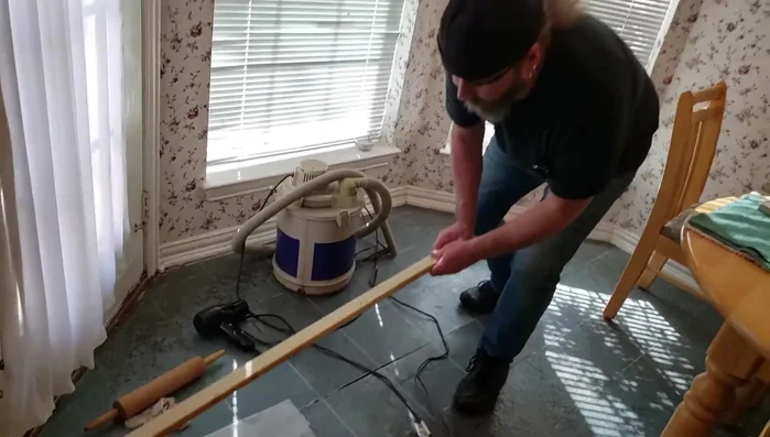 Place a flat piece of wood over the seam and apply significant weight (bricks, cinder blocks, etc.) for at least 12 hours to allow the adhesive to cure.