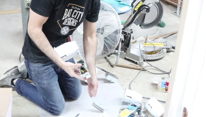 Install the plastic wire connectors in the knockout holes of the light cans.