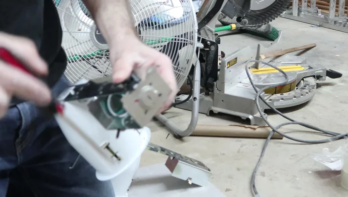 Install the plastic wire connectors in the knockout holes of the light cans.