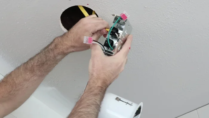 Feed the cables through the wire connectors, ensuring a secure fit and a slight bend for strain relief.