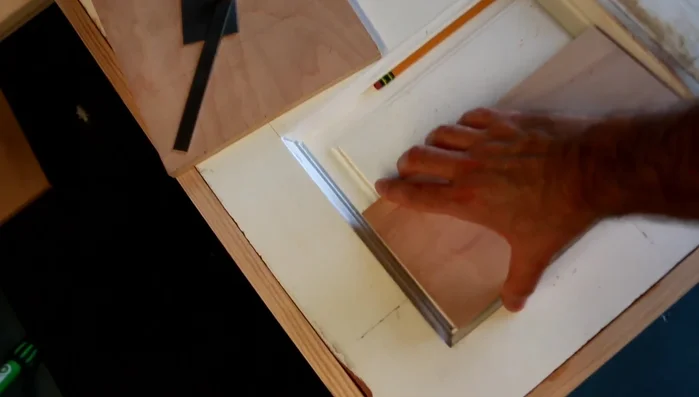 Create and inset 1/2 inch plywood panels to fill the depressions on the table surface.